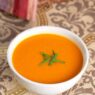 bowl of tomato and sweet potato soup with chives