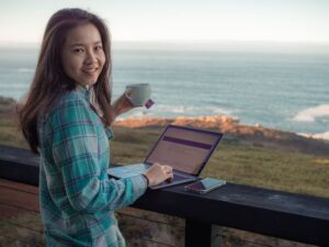 girl-working-laptop-digital-nomad-Timber-Cove-Resort-California-USA